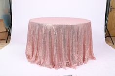 a pink table cloth on top of a white backdrop