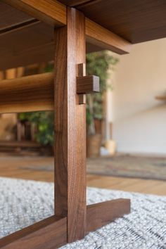 a close up of a wooden table with a cross at the top on a rug