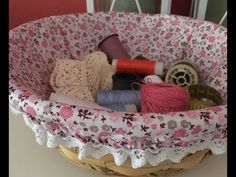 a basket filled with yarn and thread on top of a table