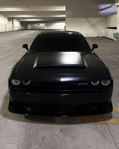 a black car parked in a parking garage