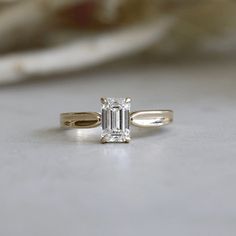 a diamond ring sitting on top of a table