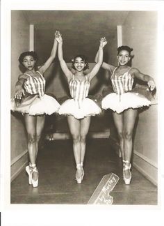 three women dressed in striped costumes and ballet shoes, one is holding her arms up