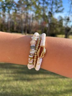 One-of-a-kind! Lightly colored ( pink, white, blue, and gold 🤍.  Lot/Set of 3 handmade bracelets.  Accent Bead : gold glass beads, rocks, and, sea shell charm.  Beads : Clay Beads, Glass Beads, and rocks Size: 7.00 inch diameter  Set: 3 Bracelets Summer Jewlery, Beads Clay, Pink Sea, Charm Beads, Gold Glass, Crafty Things, Blue And Pink, Sea Shell, Clay Beads