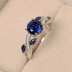 an engagement ring with blue sapphires and diamonds