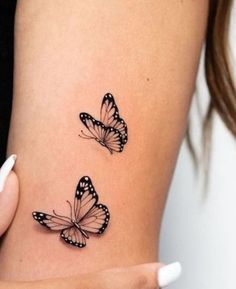 two butterflies on the side of a woman's stomach