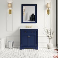 a bathroom with a blue vanity and mirror on the wall next to a white tiled floor