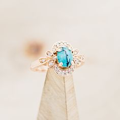 a close up of a ring on top of a piece of wood with diamond accents