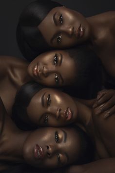 three beautiful women with black hair are posing for the camera, all wearing gold makeup