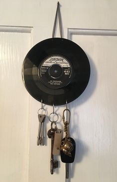 a record hanging on the wall with keys attached to it