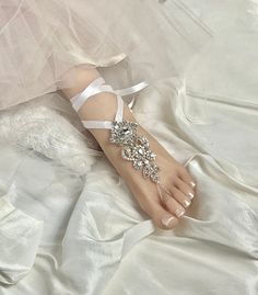 -- Wedding Barefoot Sandals, Bridal Foot Jewelry, Beach Sandals, Silver Rhinestone Foot Jewelry, Footless Sandal- FT049 -- This stunning silver rhinestone footless sandal is the perfect accessory for a beach or garden wedding. This sandal is made clear rhinestone applique and satin ribbon. You can change the satin ribbon color. It can be easily tied around the ankle for a perfectly adjustable and easy fit. It is very comfortable and adjustable. Model in photo above is a US Size 7.5 . **This list Elegant Wedding Toe Post Sandals, Adjustable Rhinestone Barefoot Sandals For Wedding, Wedding Barefoot Sandals With Rhinestones, Elegant Rhinestone Barefoot Sandals For Summer, Wedding Sandals With Rhinestones And Single Toe Strap, Silver Rhinestone Barefoot Sandals For Summer, Adjustable Rhinestone Barefoot Sandals For Summer, Adjustable Barefoot Sandals With Rhinestones For Summer, Silver Rhinestone Sandals For Wedding