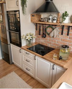 a stove top oven sitting inside of a kitchen next to a wall mounted oven range