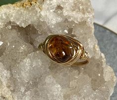 Complete your unique look with this one of a kind, handmade wire wrapped ring. Amber natural stone ring. Size 8 OUR RINGS ARE... -100% handmade  -their own individual piece of art -Created in an at-home studio  -Made from individual crafting materials  -Natural stone, glass, resin and artistic silver plated wire Care instructions: -Wipe with clean dry cloth -Do not use harsh materials, tools or chemicals to clean -Fragile and delicate design, handle gently Proudly created in San Diego, CA Wire Wrapped Ring, Crafting Materials, Handmade Wire Wrapped, Delicate Design, Wire Wrapped Rings, Handmade Wire, Ring Unique, Stone Ring, Gift For Women