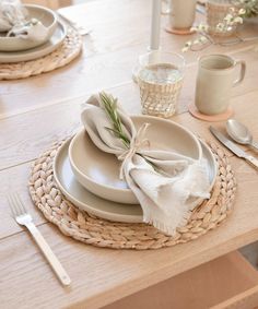 the table is set with dishes and silverware