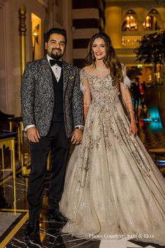 a man and woman in formal wear standing next to each other on a marble floor