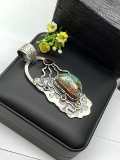 "ARTISAN ROYSTON TURQUOISE PENDANT Hand-made Sterling Silver 925. Stones used: Royston Turquoise, Garnet, multi color sapphires Height - 3 1/8\" (with bail), Width - 1 3/8\" Height - 80mm, width-36mm. Unique Handcrafted One-of a-kind Design Pendant Each Piece of Jewelry in my Collection is Absolutely One of a Kind! When you start wearing a piece of my jewelry you will fall in love with it more and more each day and feel that good Energy and Love that I pass into it while creating this piece of A Elegant Pendant Turquoise Necklace Collectible, Elegant Turquoise Pendant Necklace Collectible, Elegant Turquoise Pendant Necklace, Elegant Handmade Turquoise Chrysocolla Necklace, Artisan Sterling Silver Necklace With Gemstone Accents, Artisan Chrysocolla Jewelry For Collectors, Unique Sterling Silver Cabochon Turquoise Necklace, Artisan Pendant Jewelry With Gemstone Accents, Sterling Silver Pendant With Gemstone Accents