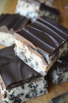 four pieces of chocolate and white cake on a cutting board