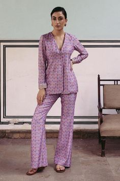 Lilac full sleeve suit with floral print in stripe pattern and aari, mirror, anchor threads, sequin embroidered sleeve hem. Paired with pant.
Components: 2
Pattern: Printed, Embroidery
Type Of Work: Floral, aari, mirror, anchor thread, sequin
Neckline: V neck
Sleeve Type: Full sleeves
Fabric: Dupion Silk, Lining: Crepe
Color: Purple
Other Details: 
Front button detailing
Embroidered sleeve hem
Length:
Suit: 28 inches
Front Neck: 10.5
Sleeves: 22 inches
Pant: 42 inches
Occasion: Cocktail - Aza Fa Embroidered Cuffs, Blouse Yoke, Print Pant, Floral Embroidered Top, Dupion Silk, Yellow Shirts, Pant Suit, Pakistani Dress Design, Embellished Top