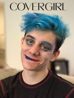 a man with blue hair and makeup on his face