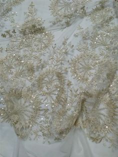 "This stunning Lace Fabric design piece has soft hand feel, It's perfect for weddings, bridal parties, and any events. Shop our large inventory of bridal fabrics. ☆PRODUCT DESCRIPTION : This gorgeous fabric is made on a sheer base with a beautiful vintage embroidery and delicate beaded throughout. The fabric width is approximately 51\" (130cm) Wide. Color: light champagne as in picture Material: Rayon, Polyester，Sequins, Pearls ☆ PURCHASING INFORMATION: This fabric is sold by the yard and each Q Glamorous Gold Embroidered Wedding Dress, Embellished Lace Mother Of The Bride Dress For Banquet, Champagne Sequin Fabric For Wedding, Sparkling Champagne Sequin Fabric For Wedding, Champagne Sparkling Sequin Fabric For Wedding, Gold Embellished Wedding Dress For Party, Embellished Gold Wedding Dress For Party, Festive Embellished Mother Of The Bride Dress For Wedding, Glamorous Sequined Tulle Fabric For Wedding