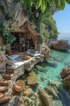 an outdoor living area with water and rocks