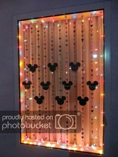 a lighted window with mickey mouse heads on it