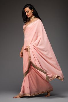 Pink saree highlighted with zardozi and mirror embroidery. Comes with cutout georgette blouse.
Components:2
Pattern:Embroidered
Type of Work:Floral
Neckline:Leaf
Sleeve Length:Sleeveless
Fabric:Georgette
Color:Pink
Other Details:
Cutout blouse
Occasion:Destination Wedding, Sangeet - Aza Fashions Mirror Embroidery, Cutout Blouse, Embroidered Saree, Georgette Blouse, Blouse For Women, Pink Saree, Saree With Blouse, Blouse Online, Pink Blouse