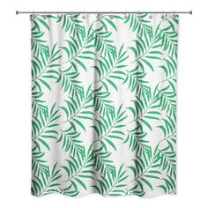 a shower curtain with green leaves on it