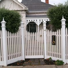 a white picket fence in front of a house