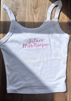 Stand out from the crowd and make a lasting impression with our Custom Embroidered Crop Top Tank. Perfect for team uniforms, bridal parties, bachelorette gifts, or retail merchandise! ✨Please note that my processing times are 2-3 weeks, and that does not include shipping time. Shipping time is an additional 3-5 business days, depending on the type of shipping you select at checkout. Please do not leave "need by" instructions in the notes, they will not be honored.✨ -52% cotton, 48% polyester. Th Fitted White Top With Machine Embroidery, Fitted White Tops With Machine Embroidery, White Fitted Top With Machine Embroidery, Fitted White Tops With Embroidered Text, White Fitted Tops With Custom Embroidery, Tank Top Embroidery, Business Merch, Bach Weekend, Embroidered Tank Top