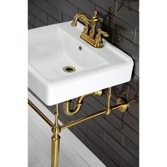 a white sink sitting on top of a bathroom counter next to a wall mounted faucet