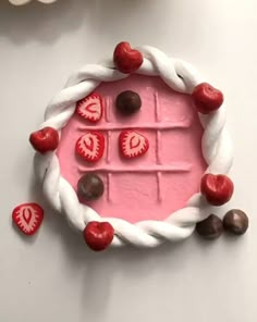 a cake made to look like an ice cream with chocolates on top and hearts in the middle