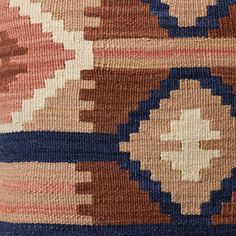 an old rug is shown with blue, brown and pink colors on it's surface