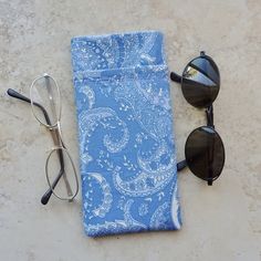 "This double eyeglass case is a great organizer case for 2 pairs of eyeglasses. Made up in a soft blue paisley cotton fabric, there is a blue cotton fabric lining. Case has 2 pockets. The main pocket will accommodate your sunglasses or eyeglasses and the outside pocket is an easy slip in for your readers or a second pair of glasses. Both pockets are fully lined and interfaced for good structure. The outside pocket has a decorative embroidery top stitching. If you prefer, an alternate use for thi Classic Blue Rectangular Cases, Classic Blue Rectangular Case, Portable Blue Cases For Personal Use, Portable Blue Case For Personal Use, Blue Rectangular Case For Everyday Use, Blue Rectangular Case For Personal Use, Decorative Embroidery, Blue Cotton Fabric, Leopard Print Fabric