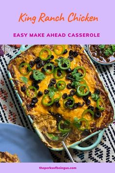 a casserole dish with black olives and green peppers in it on a table