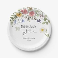 a paper plate with flowers and the words nothing fancy just love on it's side