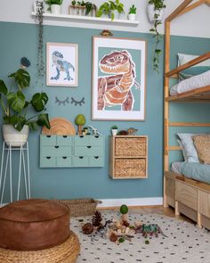 a bedroom with blue walls and plants on the wall