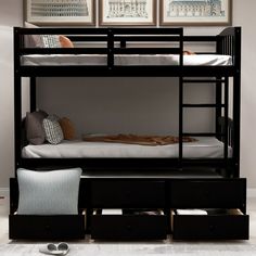 a bunk bed with drawers underneath it and pictures above the bed on the wall behind it