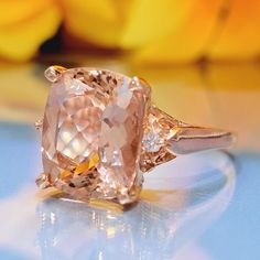 5.15 Carat Natural Peach Morganite & Diamonds 14k Solid Gold Ring Ring Material: 14k Solid Gold Approximate Weight: 3.7 Grams Gemstone: Natural Morganite Gemstone Color: Peach Gemstone Shape: Cushion Gemstone Dimensions: 12.00x10.00 mm Approximate Carat Weight: 5.05 Carat Gemstone Quantity: 1 Natural Round Shaped Diamonds Diamonds Quantity: 2 Diamonds Total Carat Weight: 0.10 Carat Approximate Total Carat Weight: 5.15 Carat Ring Quantity: One Ring Condition: New Made in the USA Delivered in an e Heirloom Morganite Diamond Ring For Formal Occasions, Formal Morganite Diamond Ring With Vvs Clarity, Classic Morganite Cushion Cut Rings, Formal Rose Gold Rings Gia Certified, Classic Morganite Gemstone Rings, Morganite Rings Gia Certified For Anniversary, Morganite Ring With Prong Setting For Formal Occasions, Gia Certified Morganite Rings In Fine Jewelry Style, Luxury Morganite Cushion Cut Rings