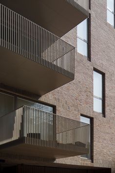 an apartment building with balconies on the second floor