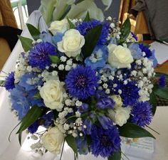 a blue and white bouquet sitting on top of a table