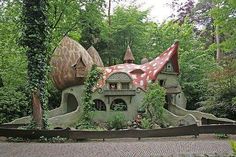 a mushroom like house in the middle of a forest