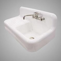 a white porcelain sink with chrome faucet