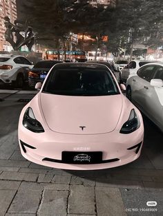 a white car parked in front of other cars