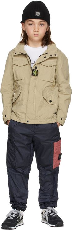 Long sleeve garment-dyed crinkled nylon and cotton-blend taffeta jacket in beige. Detachable tricolor felted logo patch at front. · Stowaway hood at stand collar · Concealed zip closure with press-stud placket · Flap pockets at chest and waist · Press-stud tab at cuffs · Elasticized adjusters at inner waistband · Nylon mesh lining · Machine wash Model measures 51 / 129.5 cm tall and wears size 8. Supplier color: Beige Supplier code: 761640330 Stone Island Junior Size : child's height 2: 36 / 92 Stone Island Kids, Taffeta Jacket, Stone Island Junior, Home Products, Stone Island, Cotton Jacket, Tri Color, Kids Clothing, Stand Collar