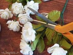 some white flowers and scissors on a table