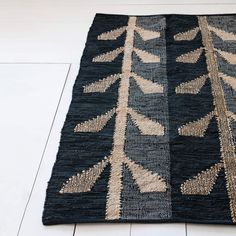 a black and beige rug on the floor