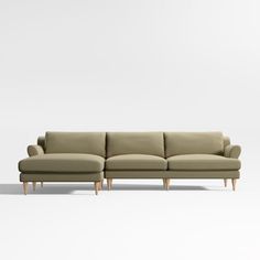 a beige couch sitting on top of a white floor