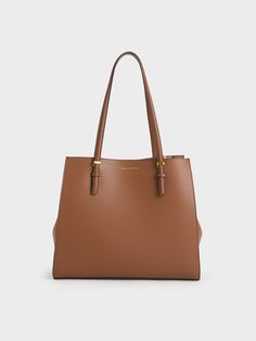 This item is part of our Online Exclusive selection, which consists of unique colourways and designs that are only available for purchase at CHARLESKEITH.COM.This product is made with at least 20% sustainable materials by weight. CHARLES & KEITH uses recycled, degradable, organic, and water-based materials in our eco-conscious collection.A tote bag that can carry everything you need is a style essential. Featuring a structured rectangular silhouette and minimalist design, the Sansa looks polishe Charles And Keith Bags Brown, Charles And Keith Tote Bag, Brown Tote Bag Outfit, Charles Keith Bags, Charles And Keith Bags, Structured Tote Bag, Bag Wishlist, Tote Bag Outfit, Charles And Keith