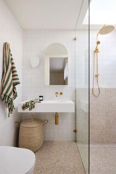 a bathroom with a sink, mirror and shower