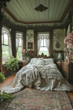 a bed sitting in a bedroom on top of a wooden floor next to a window